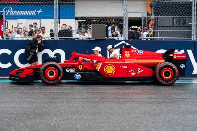 Monaco s Formula One driver Charles Leclerc and British Formula One driver Lewis Hamilton of Scuderia Ferrari drive a Lego car during the divers parade at the Formula One Miami Grand Prix at the Miami International Autodrome in Miami Gardens, Florida on Sunday, May 4, 2025.  MIA2025050435 GREGxNASH