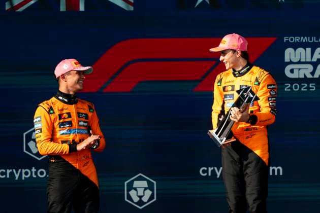 British Formula One driver Lando Norris of McLaren F1 Team shares a moment with Australian Formula One driver Oscar Piastri of McLaren F1 Team as he holds the first place trophy during a podium ceremony at the Formula One Miami Grand Prix at the Miami International Autodrome in Miami Gardens, Florida on Sunday, May 4, 2025.  MIA2025050452 GREGxNASH