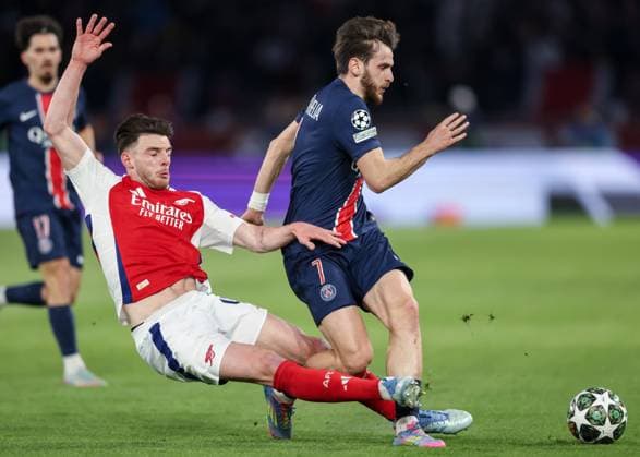 Paris, France, 7th May 2025. Declan Rice of Arsenal fouls Khvicha Kvaratskhelia of Paris Saint-Germain during the Paris Saint Germain vs Arsenal UEFA Champions League match at Le Parc des Princes, Paris. Picture credit should read: David Klein Sportimage EDITORIAL USE ONLY. No use with unauthorised audio, video, data, fixture lists, club league logos or live services. Online in-match use limited to 120 images, no video emulation. No use in betting, games or single club league player publications. SPI_045_DK_PARIS_ST_GERMAIN_V_ARSENAL SPI-3913-0044