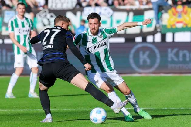 Michael Cuisance Hertha BSC Berlin and Charalambos Makridis SC Preussen Muenster battle for the ball, 2 Bundesliga, Preußen Münster vs Hertha BSC, Preußenstadion, May 9, 2025 in Münster, Germany Photo by Marco Steinbrenner DeFodi Images Michael Cuisance Hertha BSC Berlin and Charalambos Makridis SC Preussen Muenster battle for the ball, 2 Bundesliga, Preußen Münster vs Hertha BSC, Preußenstadion, May 9, 2025 in Münster, Germany Photo by Marco Steinbrenner DeFodi Images DFB DFL REGULATIONS PROHIBIT ANY USE OF PHOTOGRAPHS AS IMAGE SEQUENCES AND OR QUASI VIDEO