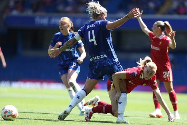Ceri Holland of Liverpool is brought down to the ground by Millie Bright of Chelsea Chelsea v Liverpool, Football, Barclays Women s Super League, Stamford Bridge, London, UK - 10 05 25 EDITORIAL USE ONLY No use with unauthorised audio, video, data, fixture lists (outside the EU), club league logos or live services. Online in-match use limited to 45 images (+15 in extra time). No use to emulate moving images. No use in betting, games or  Copyright: xAnthonyxHanc Shutterstockx 15292910j