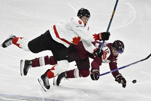 STOCKHOLM, SWEDEN 20250511 Canada s Nate MacKinnon and Latvia s Glebs Prohorenkovs during the IIHF Ice Hockey World Championship group A match between Latvia and Canada at Avicii Arena in Stockholm, Sweden, on May 11, 2025 STOCKHOLM SWEDEN x10430x  Copyright: xChristinexOlsson TTx ICE HOCKEY WC LATVIA-CANADA