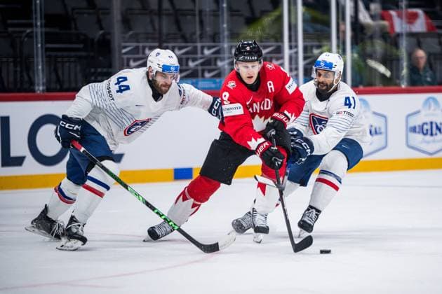 250513 Kevin Spinozzi and Pierre Edouard Bellemare of France compete for the puck with Nathan MacKinnon of Canada during the 2025 IIHF Ice Hockey World Championship group stage game between Canada and France on May 13, 2025 in Stockholm Photo Maxim Thore BILDBYRAN kod MT MT0814 ishockey ice hockey ishockey vm 2025 vm 2025 iihf world championship kanada canada frankrike france bbeng  Copyright: MAXIMxTHORE BB250513MT032