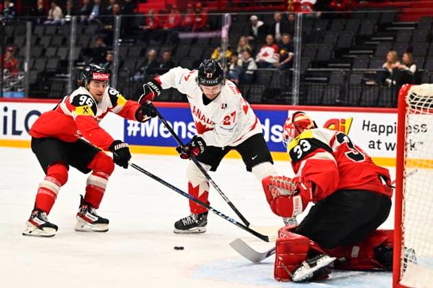 Austria s Marco Kasper, Canada s Barrett Hayton and Austria s goalkeeper Florian Vorauer during the IIHF Ice Hockey World Championship group A match between Canada and Austria at Avicii Arena in Stockholm, Sweden, on May 15, 2025 STOCKHOLM SWEDEN x10040x  Copyright: xAndersxWiklund TTx ICE HOCKEY WC CANADA-AUSTRIA
