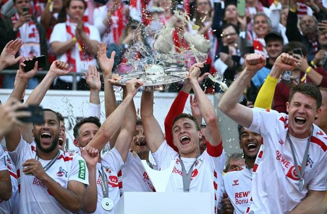 Football, Bundesliga, Germany, Men, Season 2024 2025, Matchday 34, Rhein Energie Stadion Köln, 1 FC Köln FC Kaiserslautern 4 0 Linton Maina KOE , Mark Uth KOE , Timo Hübers KOE , Dominique Heintz KOE and Marvin Schwäbe KOE cheer with the championship trophy Cheers, joy, action