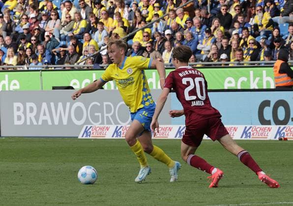 Julian Baas Eintracht Braunschweig in duel with Caspar Jander 1 FC Nuernberg Football, Men, Season 2024 2025 2 BL, Eintracht Stadion, Eintracht Braunschweig vs 1 FC Nuernberg, 1 4 Braunschweig must go into relegation DFL REGULATIONS PROHIBIT ANY USE OF PHOTOGRAPHS AS IMAGE SEQUENCES AND OR QUASI VIDEO