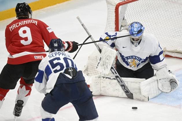 Goalkeeper Juuse Saros (R) of Finland makes a save against Nathan MacKinnon of Canada during the 2025 IIHF Ice hockey, Eishockey World Championships preliminary round group A match between Canada and Finland in Stockholm on May 19, 2025, Mikael Seppälä of Finland follows. Stockholm Sweden LKFTJK20250519231317LHKA  Copyright: xVesaxMoilanenx LKFTJK20250519231317LHKA