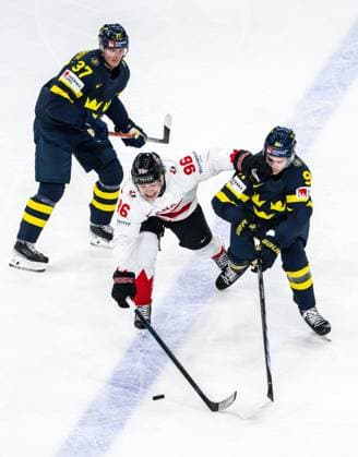 250520 Macklin Celebrini of Canada against Isac Lundeström and Leo Carlsson of Sweden during the 2025 IIHF Ice Hockey World Championship group stage game between Sweden and Canada on May 20, 2025 in Stockholm Photo Simon Hastegard BILDBYRAN kod SH JM0689 ishockey ice hockey ishockey vm 2025 vm 2025 iihf world championship sverige sweden kanada canada bbeng gruppspel  Copyright: SIMONxHASTEGARD BB250520SH016