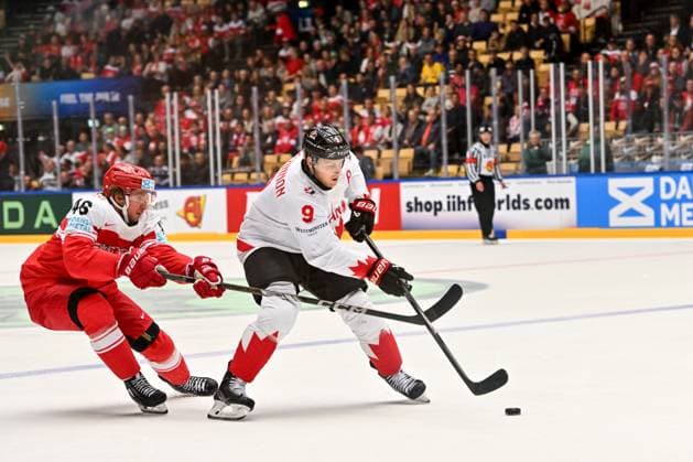 ODENSE, DENMARK MAY 22 Nathan Mackinnon of Canada protects the puck from Jonas Rondbjerg of Denmark during the 2025 Ice Hockey World Championship match between Canada and Denmark at Jyske Bank Arena on May 22, 2025 in Odense, Denmark Odense Jyske Bank Arena Denmark Copyright: xJustPictures.ch AndreaxBrancax jp-en-EuSpIm-AB_22052025_AAB_0674