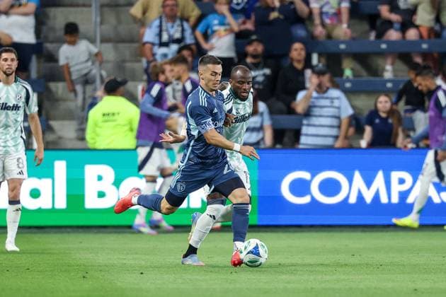 May 24, 2025: Sporting Kansas City midfielder Erik Thommy (26) and New England Revolution forward Ignatius Ganago (17) battle for the ball during the second half at Childrens Mercy Park in Kansas City, KS. CSM Kansas City United States of America - ZUMAc04_ 20250524_zma_c04_420 Copyright: xDavidxSmithx