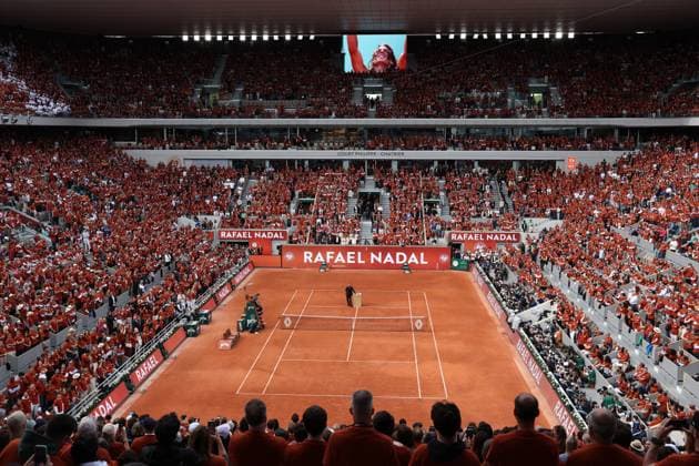 Tennis great, Rafael Nadal of Spain, stands alone before a large crowd during a tribute ceremony in his honor, on the first day of the Roland Garros French Tennis Open in Paris, France, on Sunday, May 25, 2025. Nadal was honored in a special farewell ceremony that celebrated his extraordinary legacy in Paris.  PAR20250525115 MAYAxVIDON-WHITE