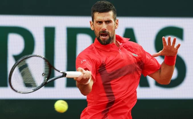 (250530) -- PARIS, May 30, 2025 -- Novak Djokovic of Serbia hits a return during the men s singles second round match against Corentin Moutet of France at French Open tennis tournament 2025 in Paris, France, May 29, 2025. ) (SP)FRANCE-PARIS-TENNIS-FRENCH OPEN-MEN S SINGLES GaoxJing 