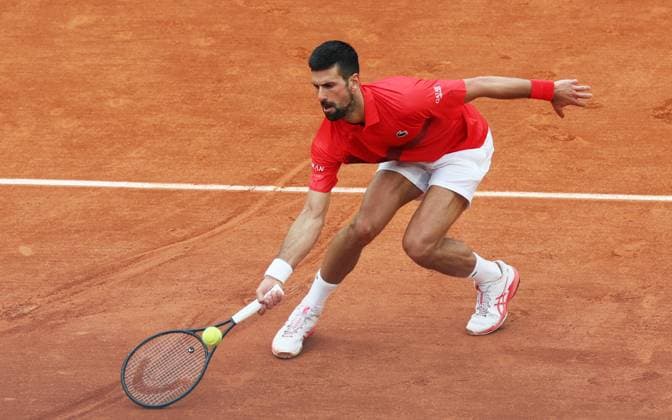 (250530) -- PARIS, May 30, 2025 -- Novak Djokovic of Serbia hits a return during the men s singles second round match against Corentin Moutet of France at French Open tennis tournament 2025 in Paris, France, May 29, 2025. ) (SP)FRANCE-PARIS-TENNIS-FRENCH OPEN-MEN S SINGLES GaoxJing 
