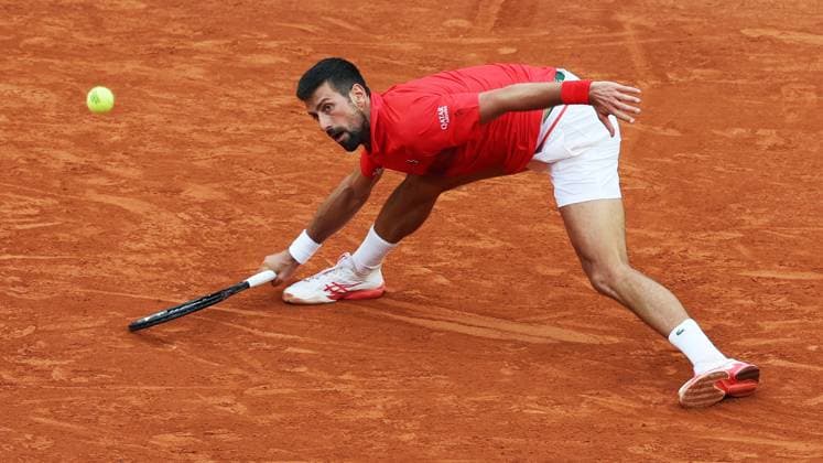 (250530) -- PARIS, May 30, 2025 -- Novak Djokovic of Serbia hits a return during the men s singles second round match against Corentin Moutet of France at French Open tennis tournament 2025 in Paris, France, May 29, 2025. ) (SP)FRANCE-PARIS-TENNIS-FRENCH OPEN-MEN S SINGLES GaoxJing 