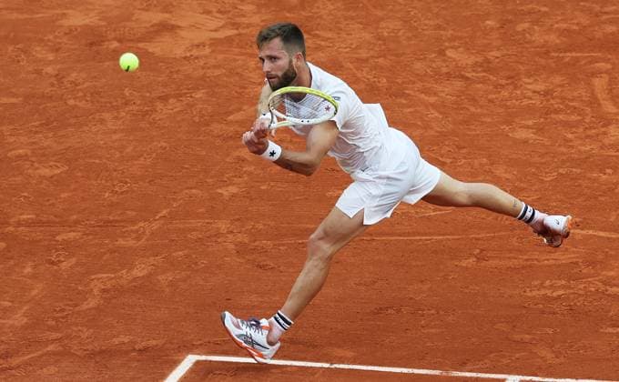 (250530) -- PARIS, May 30, 2025 -- Corentin Moutet of France hits a return during the men s singles second round match against Novak Djokovic of Serbia at French Open tennis tournament 2025 in Paris, France, May 29, 2025. ) (SP)FRANCE-PARIS-TENNIS-FRENCH OPEN-MEN S SINGLES GaoxJing 