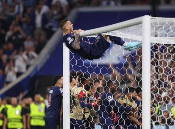 Munich, Germany, 31st May 2025. Lucas Hernandez of Paris St Germain swings on the bar as Senny Mayulu of Paris St Germain celebrates scoring their fifth goal during the Paris Saint Germain vs Internazionale UEFA Champions League Final match at Munich Football Arena, Munich. Picture credit should read: David Klein Sportimage EDITORIAL USE ONLY. No use with unauthorised audio, video, data, fixture lists, club league logos or live services. Online in-match use limited to 120 images, no video emulation. No use in betting, games or single club league player publications. SPI_100_DK_UCL_Final SPI-3964-0101