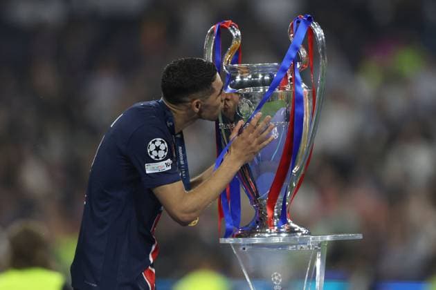 Achraf Hakimi of PSG kiss the trophy Paris Saint-Germain v Inter Milan, UEFA Champions League Final, Football, Allianz Arena, Munich, Germany - 31 May 2025 EDITORIAL USE ONLY No use with unauthorised audio, video, data, fixture lists, club league logos or live services. Online in-match use limited to 120 images, no video emulation. No use in betting, games or single club league player publications. Copyright: xAhmadxMora Shutterstockx 15330932au