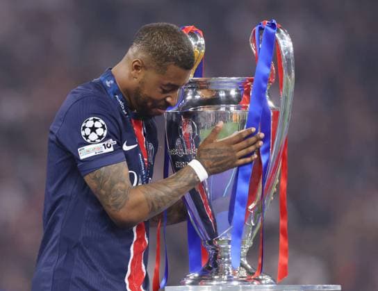 Munich, Germany, 31st May 2025. Presnel Kimpembe of Paris St Germain touches the trophy in celebration during the Paris Saint Germain vs Internazionale UEFA Champions League Final match at Munich Football Arena, Munich. Picture credit should read: David Klein Sportimage EDITORIAL USE ONLY. No use with unauthorised audio, video, data, fixture lists, club league logos or live services. Online in-match use limited to 120 images, no video emulation. No use in betting, games or single club league player publications. SPI_130_DK_UCL_Final SPI-3964-0132