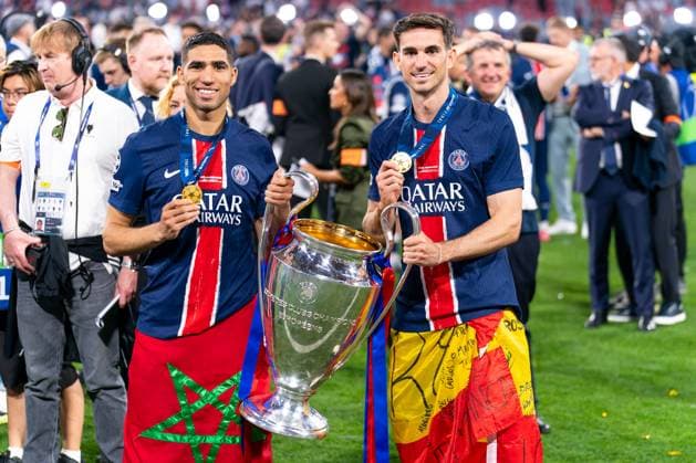 2025-05-31 Paris Saint-Germain v FC Internazionale Milano - UEFA Champions League Final 2025 MUNICH, GERMANY - MAY 31: Achraf Hakimi of Paris Saint-Germain and Fabian Ruiz of Paris Saint-Germain with the trophy after the UEFA Champions League Final 2025 match between Paris Saint-Germain and FC Internazionale Milano at Munich Football Arena on May 31, 2025 in Munich, Germany. Munich Munich Football Arena Germany Content not available for redistribution in The Netherlands directly or indirectly through any third parties. Copyright: xJorisxVerwijstx