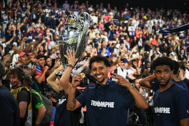 PSG celebrates Champions League trophy at Parc des Princes - FA Paris Saint-Germain’s defender Marquinhos looks on next to Paris Saint-Germain’s midfielder Lee Kang-in as Paris Saint-Germain’s players celebrate the UEFA Champions League trophy at the Parc des Princes Stadium in Paris on June 1, 2025, the day after PSG won the UEFA Champions League final football match over Inter Milan in Munich, on May 31, 2025. Photo by Firas Abdullah ABACAPRESS.COM Paris Ile-de-France France  Copyright: xAbdullahxFiras ABACAx