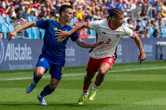 June 7, 2025, Toronto, Ontario, Canada: Zorhan Bassong 2 (R) battles for the ball against Oleksandr Tymchyk 18 (L) during the Canadian Shield Tournament match at BMO Field on June 7, 2025 in Toronto, Ontario, Canada. The game ended 4-2 for Canada Toronto Canada - ZUMAm154 20250607_zap_m154_008 Copyright: xAngelxMarchinix