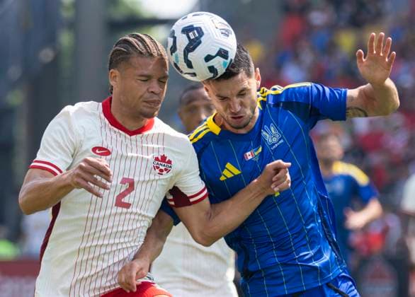 (250608) -- TORONTO, June 8, 2025 -- Zorhan Bassong (L) of Canada vies for a header with Roman Yaremchuk of Ukraine during the Canadian Shield Tournament football match between Canada and Ukraine at BMO Field in Toronto, Canada, June 7, 2025. (Photo by Xinhua) (SP)CANADA-TORONTO-FOOTBALL-CANADIAN SHIELD TOURNAMENT-CANADA VS UKRAINE ZouxZheng 