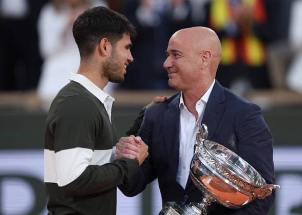 Andre Agassi presents the trophy to Carlos Alcaraz of Spain French Open Tennis, Day Fifteen, Tennis, Roland Garros, Paris, France - 08 Jun 2025 EDITORIAL USE ONLY No use with unauthorised audio, video, data, fixture lists, club league logos or live services. Online in-match use limited to 120 images, no video emulation. No use in betting, games or single club league player publications. Copyright: xEllaxLing Shutterstockx 15346226db