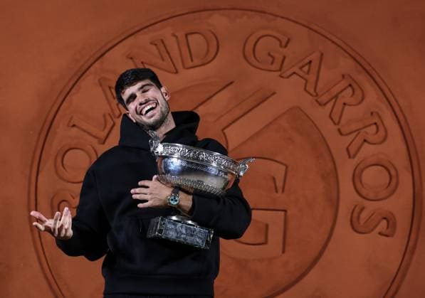 (250609) -- PARIS, June 9, 2025 -- Carlos Alcaraz poses for photos with the trophy after winning the men s singles final match between Jannik Sinner of Italy and Carlos Alcaraz of Spain at the French Open tennis tournament at Roland Garros, Paris, France, June 8, 2025. ) (SP)FRANCE-PARIS-TENNIS-FRENCH OPEN-MEN S SINGLES-FINAL LixJing 