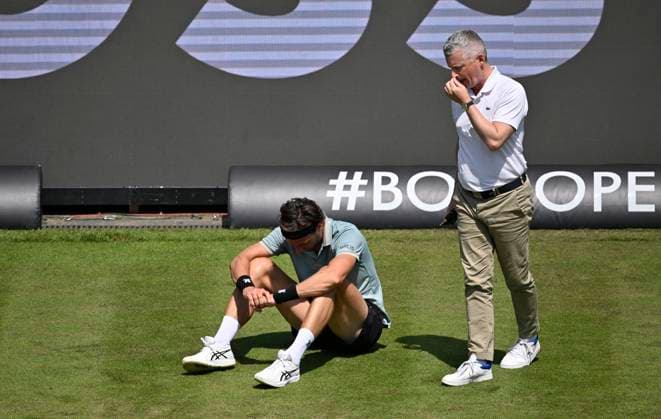 Arthur Rinderknech FRA lies injured on the ground Injury Chair umpire Timo Janzen takes care of himself Tennis Men BOSS Open ATP 250 Stuttgart 2025 Weissenhof BOSS Open ATP 250 Stuttgart 2025