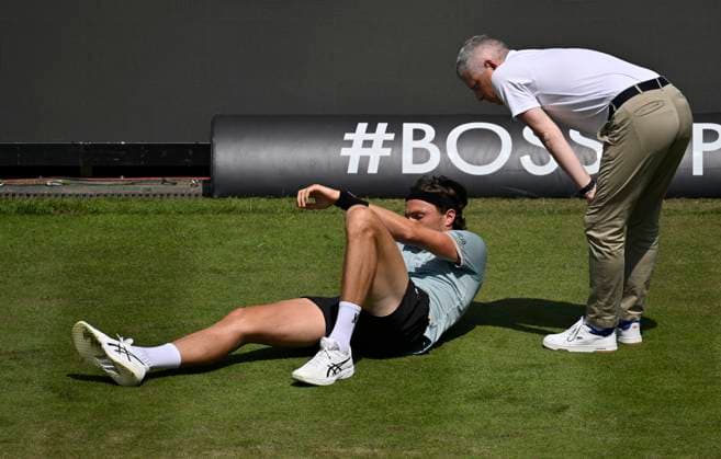 Arthur Rinderknech FRA lies injured on the ground Injury Chair umpire Timo Janzen takes care of himself Tennis Men BOSS Open ATP 250 Stuttgart 2025 Weissenhof BOSS Open ATP 250 Stuttgart 2025