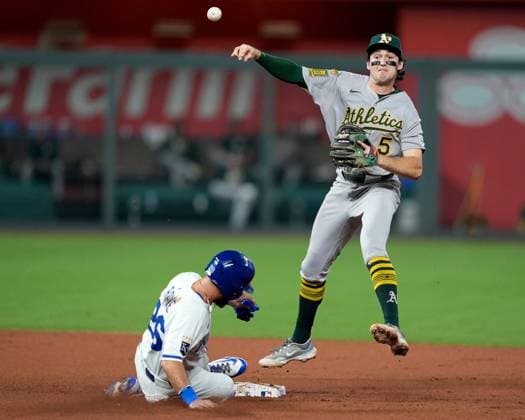 June 13, 2025: Athletics shortstop Jacob Wilson (5) turns a double play over Kansas City Royals outfielder John Rave (26) at Kauffman Stadium Kansas City, Missouri. CSM. Kansas City United States - ZUMAc04_ 20250613_zma_c04_033 Copyright: xJonxRobichaudx