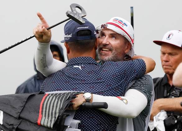 J.J. Spaun celebrates with his caddie Mark Caren after winning the 125th U.S. Open Golf Championship at Oakmont Country Club in Oakmont, Pennsylvania on Sunday, June 15, 2025. Spaun won with a 64-foot birdie putt on the 18th hole and finished at even par for the tournament.  PIT20250615701 JOHNxANGELILLO