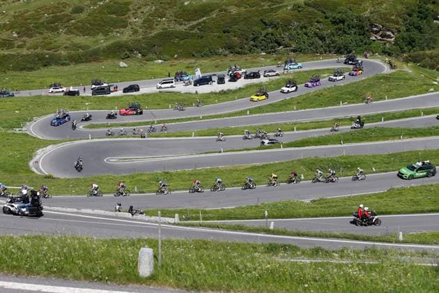 TDS 4th stage Rider and team car on Spluegen Pass 18 06 2025 Spluegen Pass, SWITZERLAND, Tour de Suisse 4th stage Heiden Piuro Rider and team car on Spluegen Pass