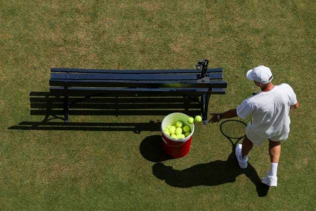 19th June 2025; HSBC Championships, Queens Club, West Kensington, London, England: HSBC Mens Championships Queens Club, Day 4; Member of Carlos Alcaraz (ESP) coaching staff collects tennis balls during a practice session  ActionPlus12802634 HenningxVonxJagow