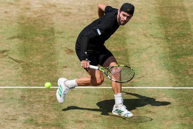 19th June 2025; HSBC Championships, Queens Club, West Kensington, London, England: HSBC Mens Championships Queens Club, Day 4; Jacob Fearnley (GBR) plays a backhand shot against Corentin Moutet (FRA)  ActionPlus12802657 HenningxVonxJagow