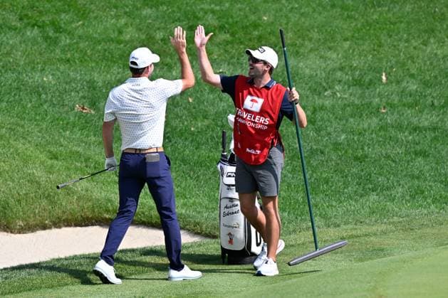 June 19, 2025: Austin Eckroat of Edmond, OK, celebrates with his caddy after making his shot from a bunker into the cup on the fifteenth hole during the second round of the PGA, Golf Herren Travelers Championship golf tournament held at TPC River Highlands in Cromwell CT. Cal Media Cromwell USA - ZUMAc04_ 20250620_zma_c04_080 Copyright: xEricxCanhax
