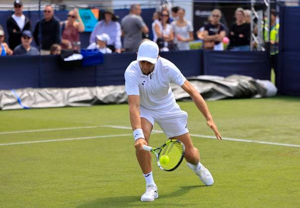 22nd June 2025; Devonshire Park, Eastbourne, East Sussex, England: Lexus International Eastbourne, Qualifying Day 2; Aleksandar Vukic (AUS) plays a backhand against Jenson Brooksby (USA)  ActionPlus12804297 HongboxChen