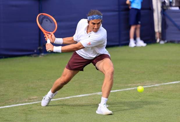 22nd June 2025; Devonshire Park, Eastbourne, East Sussex, England: Lexus International Eastbourne, Qualifying Day 2; Mattia Bellucci (ITA) plays a backhand shot against Chun-Hsin Tseng (TPE)  ActionPlus12804329 HongboxChen