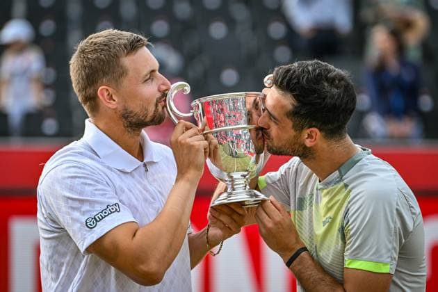 22nd June 2025; HSBC Championships, Queens Club, West Kensington, London, England: HSBC Mens Championships Queens Club, Day 7; Julian Cash (GBR) celebrates winning the mens doubles final match with partner Lloyd Glasspool (GBR) against Nikola Mektic (CRO) and Michael Venus (NZL) as they hold the trophy  ActionPlus12804559 GodfreyxPitt
