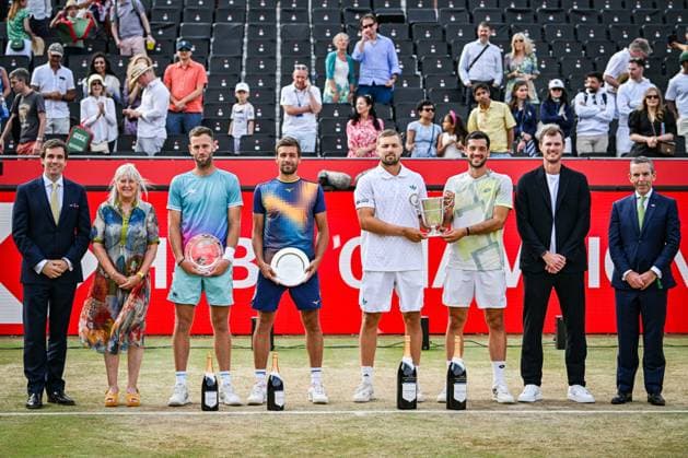 22nd June 2025; HSBC Championships, Queens Club, West Kensington, London, England: HSBC Mens Championships Queens Club, Day 7; Julian Cash (GBR) and Lloyd Glasspool (GBR) pose for photos with the presentation party and Nikola Mektic (CRO) and Michael Venus (NZL) after beating them in the mens doubles final match  ActionPlus12804571 GodfreyxPitt