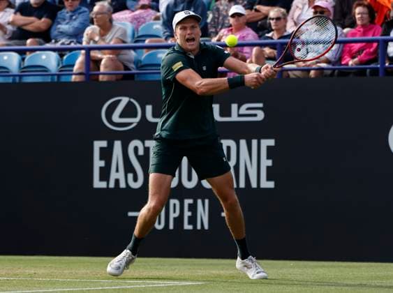 27th June 2025; Devonshire Park, Eastbourne, East Sussex, England; Lexus International Eastbourne, Day 5; Jensen Brooksby (USA) plays a backhand shot against Ugo Humbert (FRA) in the mens singles semi-final match  ActionPlus12806128 HongboxChen