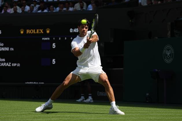 30th June 2025; All England Lawn Tennis and Croquet Club, London, England; Wimbledon Tennis Tournament, Day 1; Carlos Alcaraz (ESP) with a backhand shot to Fabio Fognini (ITA)  ActionPlus12807227 JohnxPatrickxFletcher