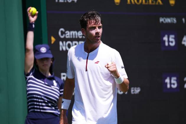 LONDON, ENGLAND - JUNE 30: Cameron Norrie of Great Britain plays a forehand against Roberto Bautista Agut of Spain during the Gentleman s Singles First Round match on day one of The Championships Wimbledon 2025 at All England Lawn Tennis and Croquet Club on June 30, 2025 in London, England  Copyright: xx
