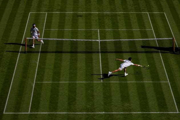 250630 Carlos Alcaraz of Spain and Fabio Fognini of Italy compete in a first round singles tennis match during day 1 of Wimbledon on June 30, 2025 in London Photo Petter Arvidson BILDBYRAN kod PA PA1043 tennis wimbledon day 1 bbeng spain italy  Copyright: PETTERxARVIDSON BB250630PA019