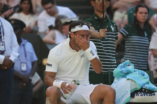 30th June 2025; All England Lawn Tennis and Croquet Club, London, England; Wimbledon Tennis Tournament, Day 1; Fabio Fognini (ITA) splashing water on his face during a break in the heatwave  ActionPlus12807300 JohnxPatrickxFletcher