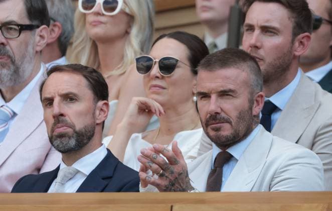 Footballer David Beckham (R) and ex England manager Graham Southgate watch tennis in the Royal Box on day one of the 2025 Wimbledon Championships in London on Monday, June 30, 2025.  LON2025063016 HUGOxPHILPOTT