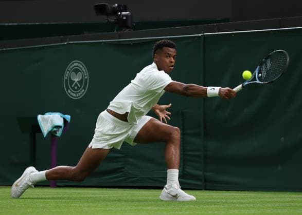 30th June 2025; All England Lawn Tennis and Croquet Club, London, England; Wimbledon Tennis Tournament, Day 1; Giovanni Mpetshi Perricard (FRA) with a backhand shot to Taylor Fritz (USA)  ActionPlus12807341 JohnxPatrickxFletcher