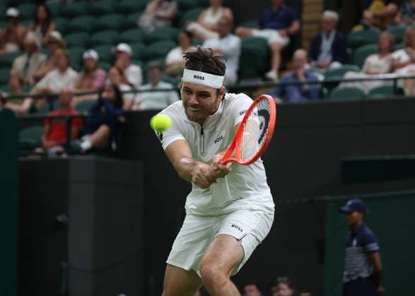 30th June 2025; All England Lawn Tennis and Croquet Club, London, England; Wimbledon Tennis Tournament, Day 1; Taylor Fritz (USA) with a backhand shot to Giovanni Mpetshi Perricard (FRA)  ActionPlus12807351 JohnxPatrickxFletcher