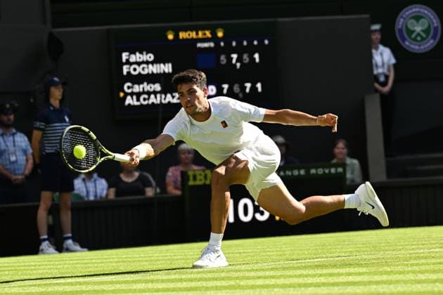 (250701) -- LONDON, July 1, 2025 -- Carlos Alcaraz hits a return during the men s singles first round match between Carlos Alcaraz of Spain and Fabio Fognini of Italy at Wimbledon Tennis Championship in London, Britain, June 30, 2025. ) ) (SP)BRITAIN-LONDON-TENNIS-WIMBLEDON-MEN S SINGLES ZhaoxDingzhe 