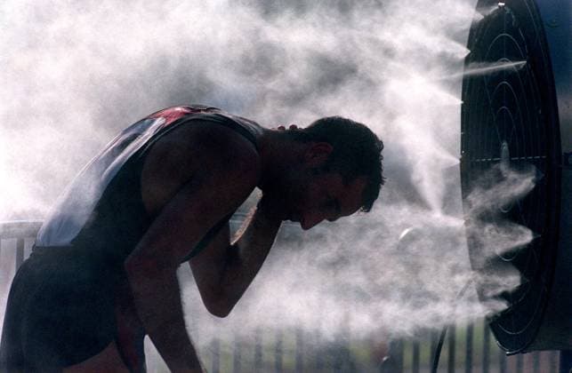 . photo4: After the finish of the Southtrust 10 mile race on Saturday mornging, runners tried to cool off in the spray of several misters. Unlike last years deluge on race day, the morning was sunny and breezy. .- -.Times Photo By:.Pam Royal.- -.Story By:.pickeral.- -.SCANNED BY:..- - RUN DATE: .10 18 98 Copyright: xStxPetersburgxTimesx